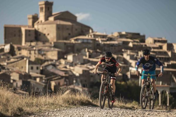 Two cyclists and a town in the background